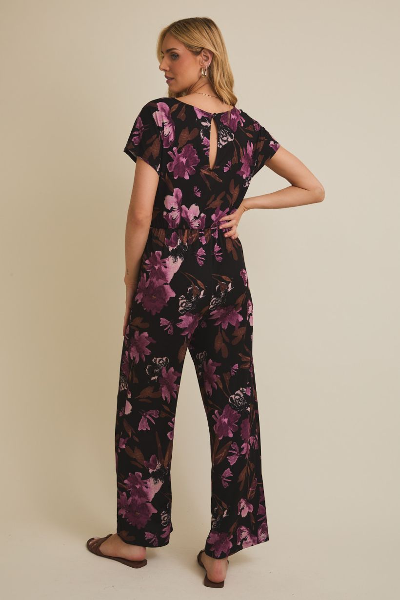 black jumpsuit with floral pattern and boat neckline