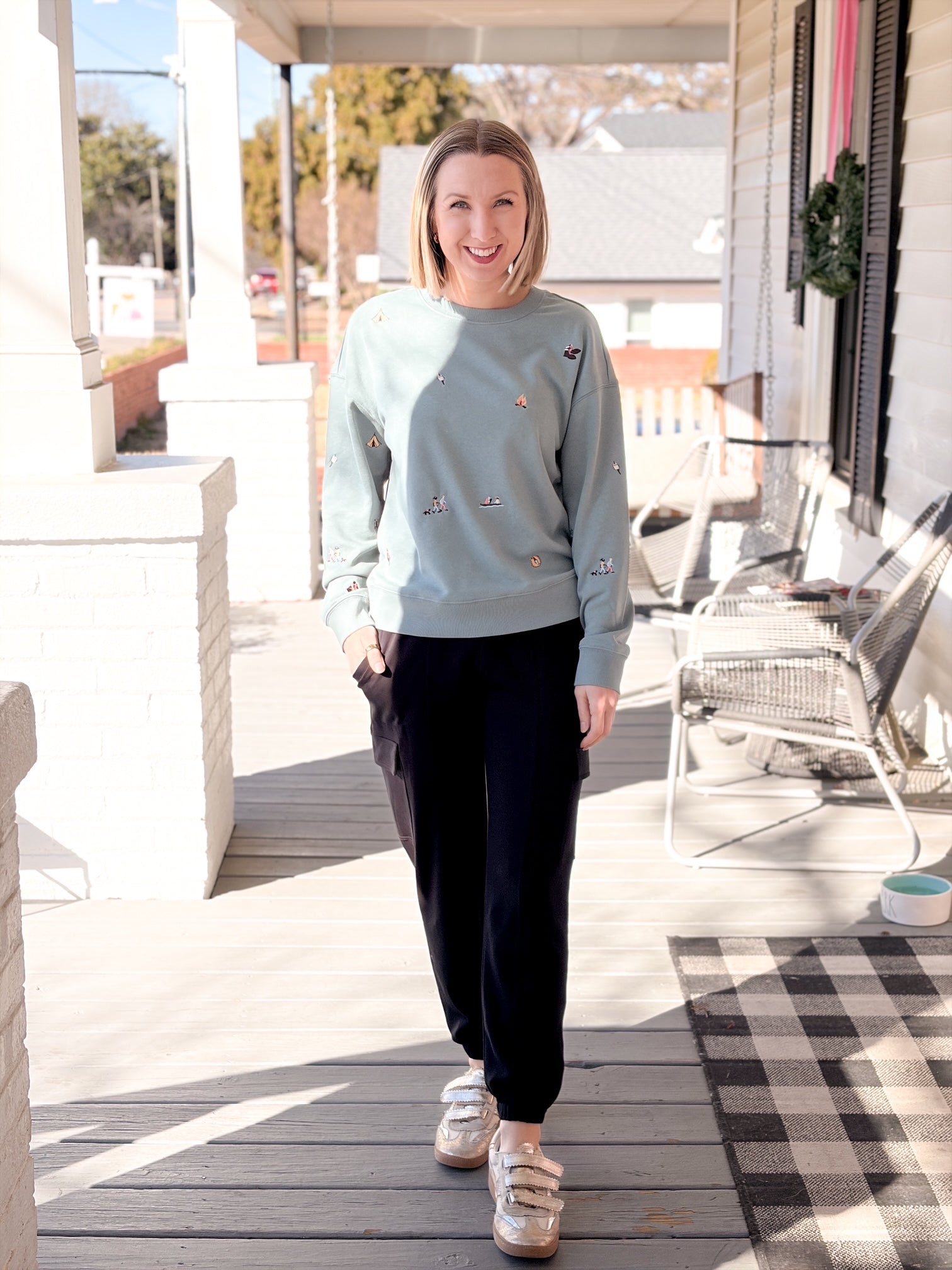 teal blue sweatshirts with small camping patterns sewn on