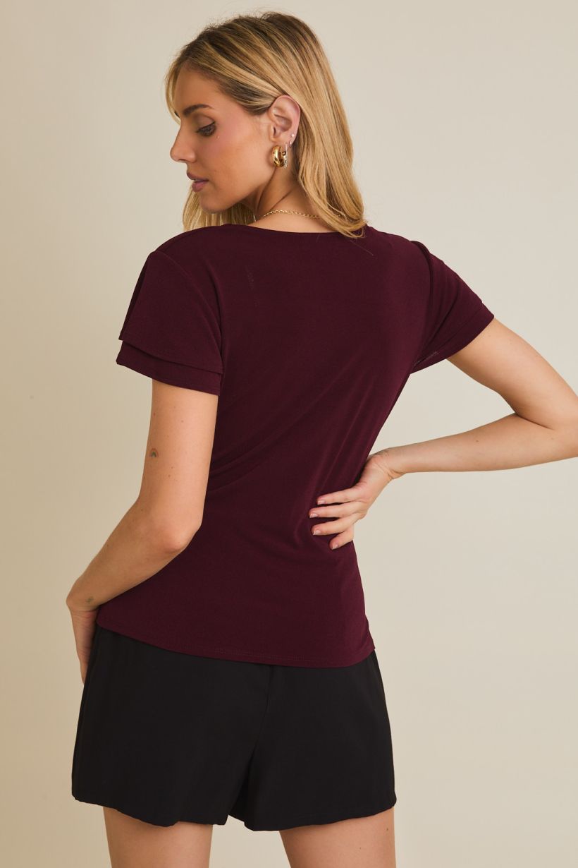 wine colored short sleeve top with v neckline and faux wrap detailing