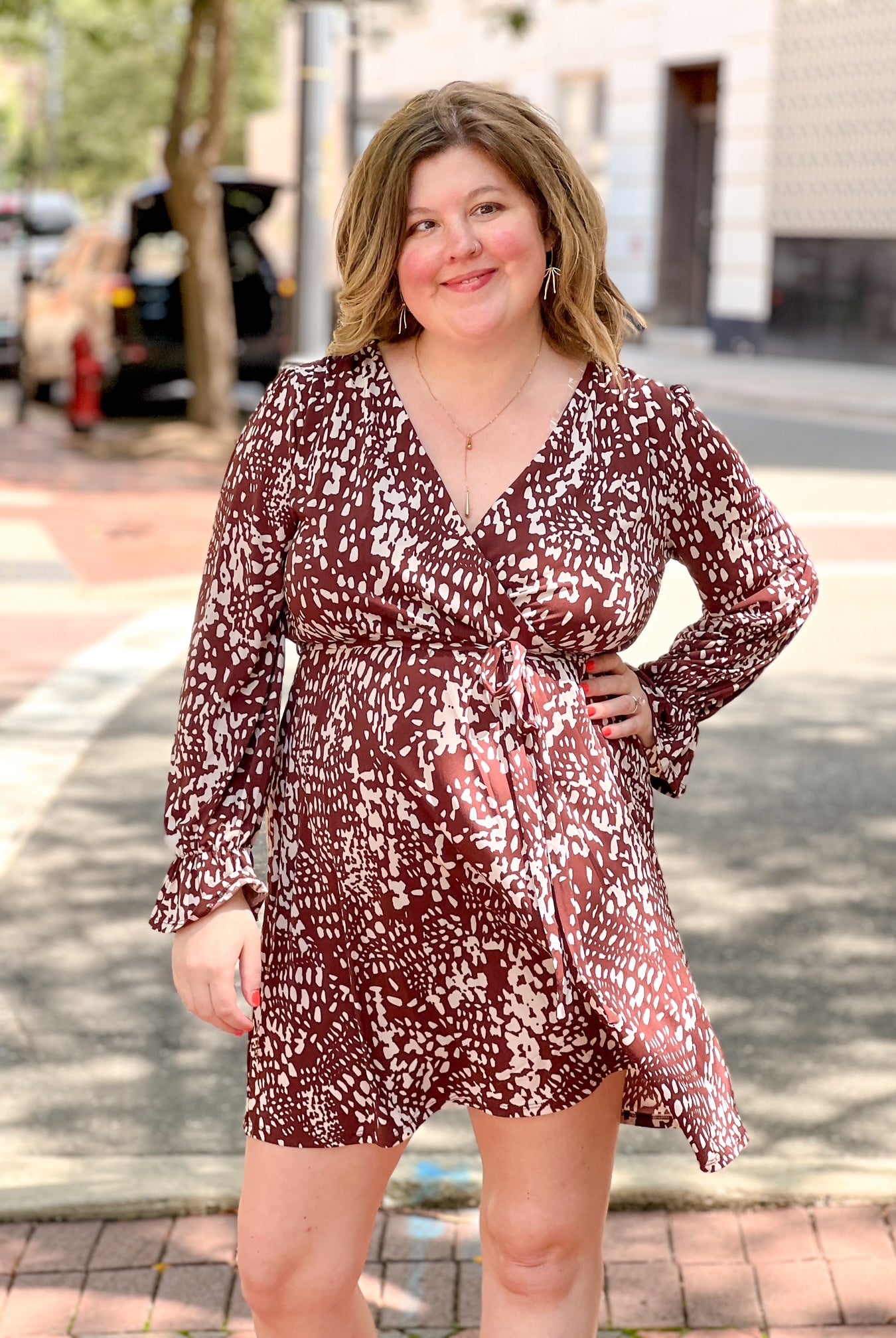 brown and cream patterned mini dress with v neckline