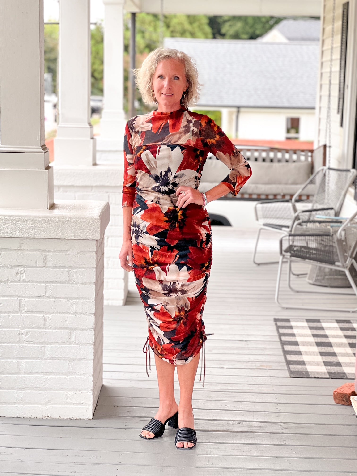 midi length orange, black and cream dress with 3/4 sleeves