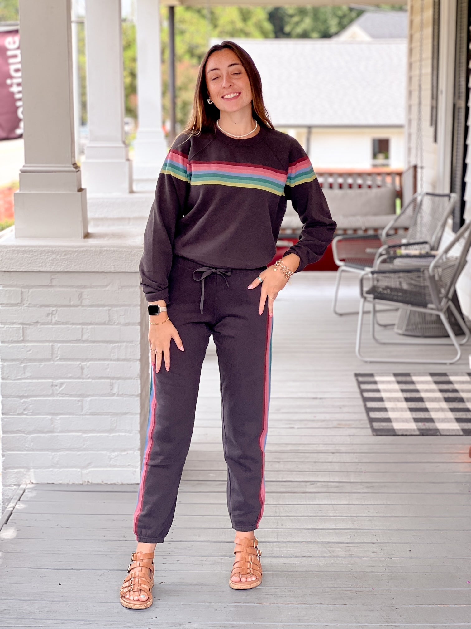 faded black sweatpants with rainbow pattern running down sides