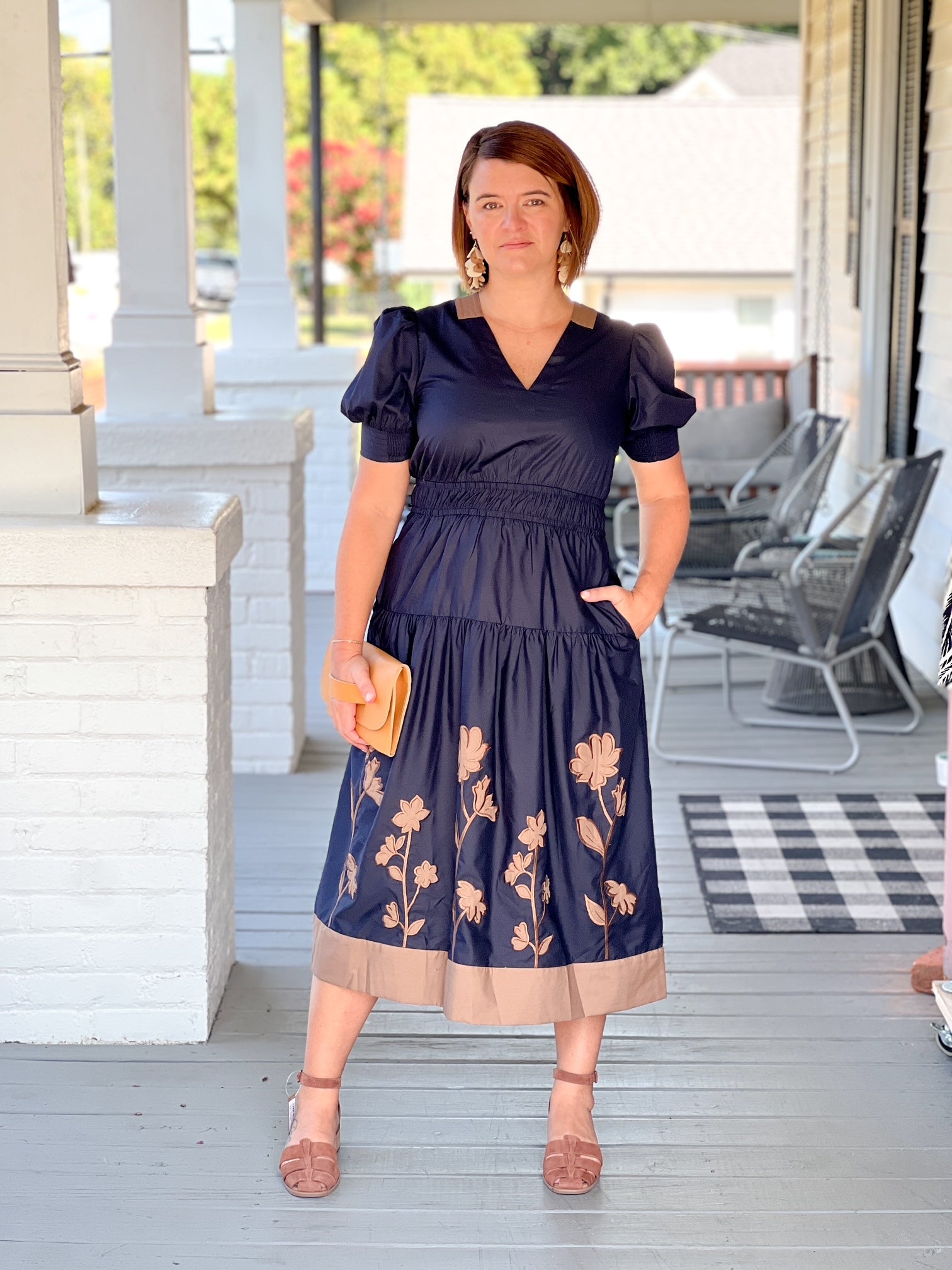 midi length dark navy dress with brown floral design and v neckline