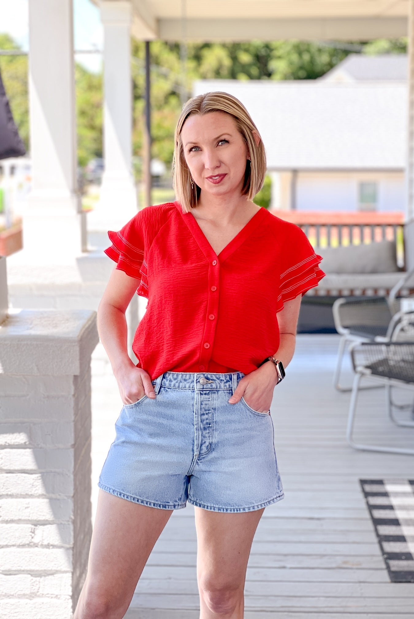 lightweight, short sleeve red top with button up detail and ruffle sleeves