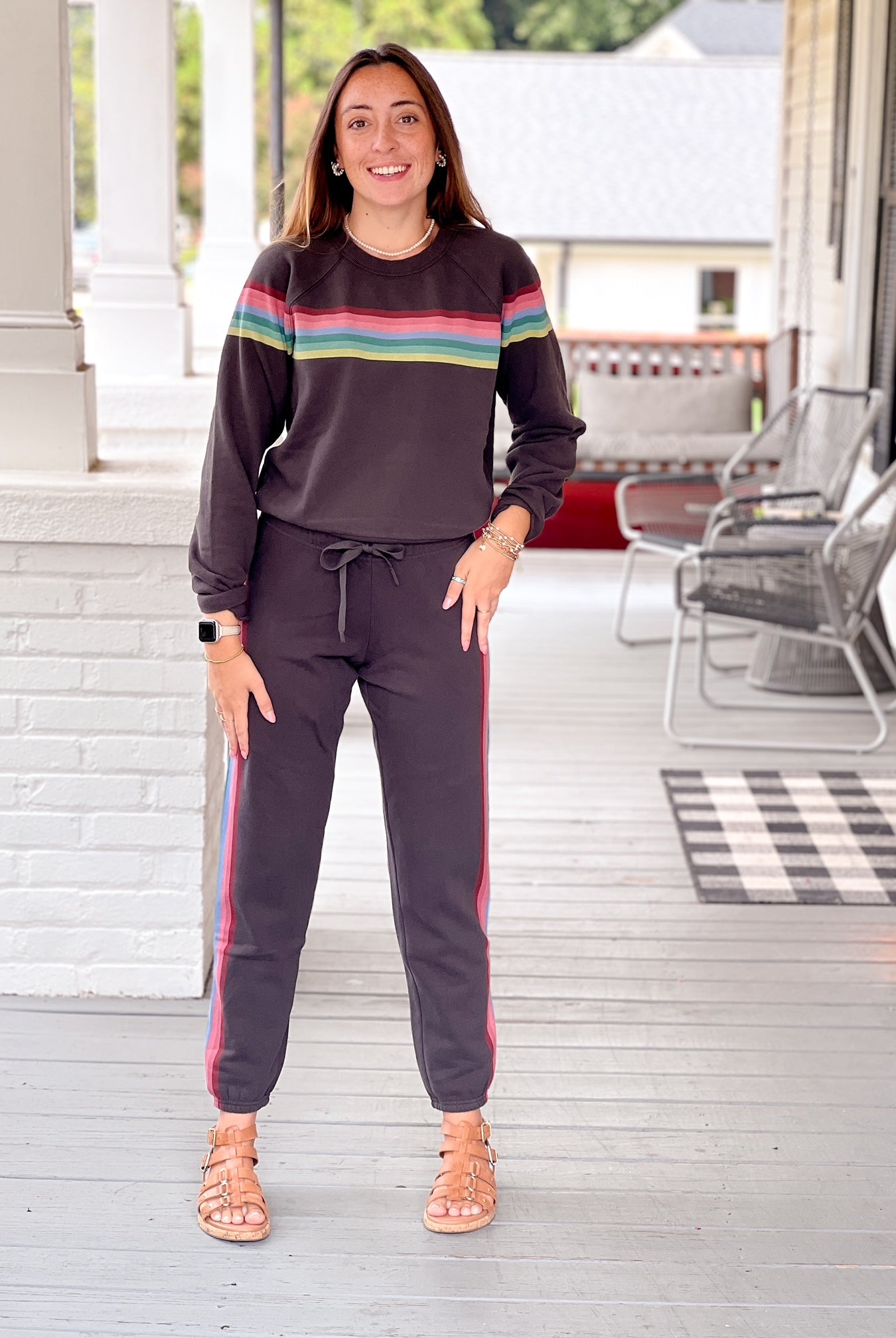 faded black sweatpants with rainbow pattern running down sides