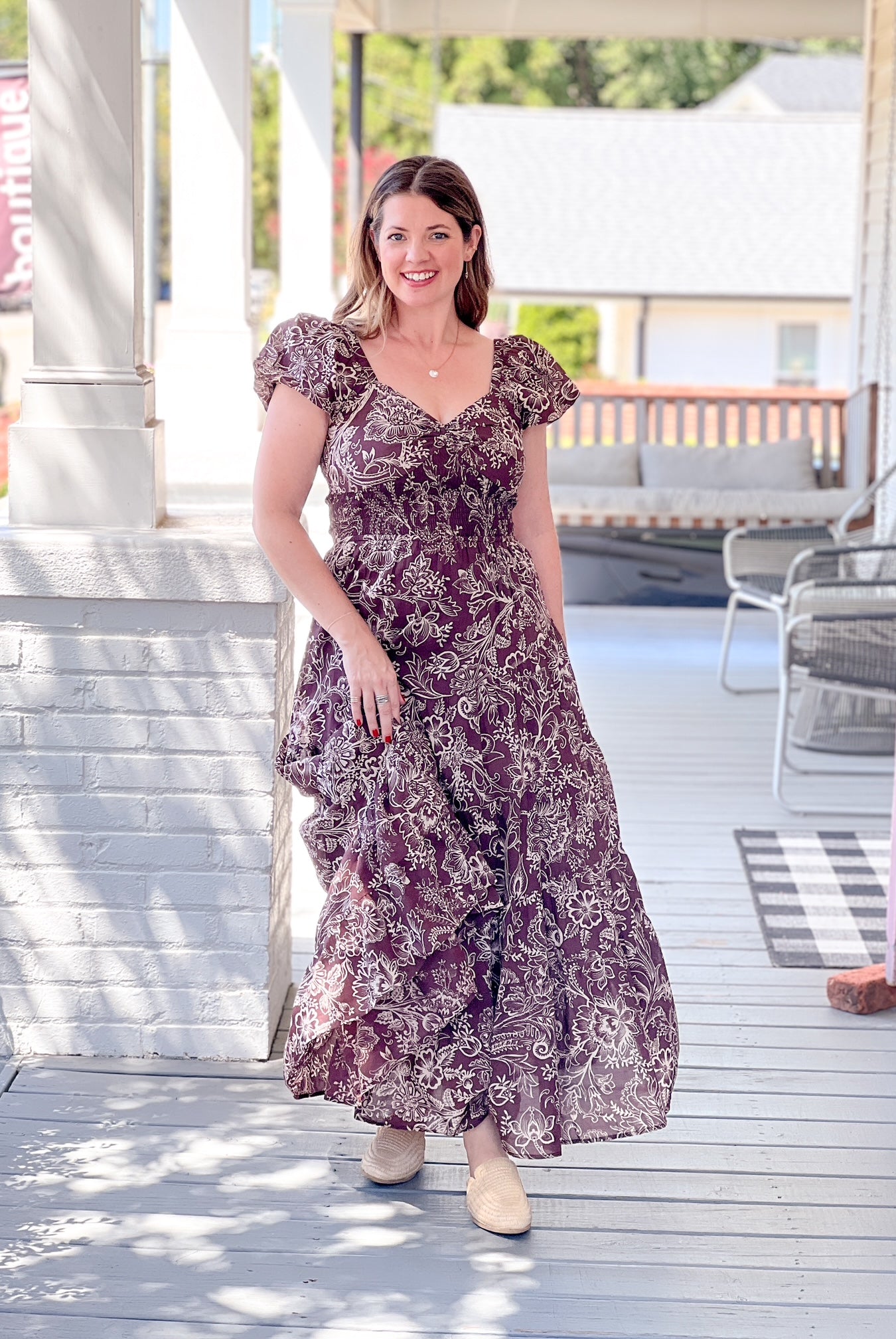 brown maxi length dress with floral pattern and sweetheart neckline