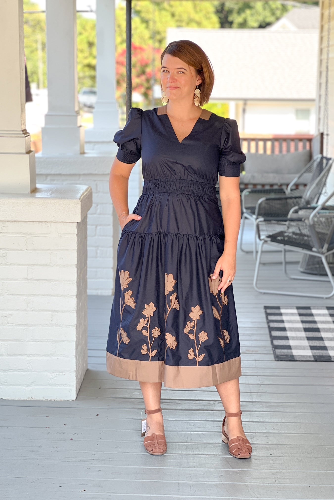midi length dark navy dress with brown floral design and v neckline