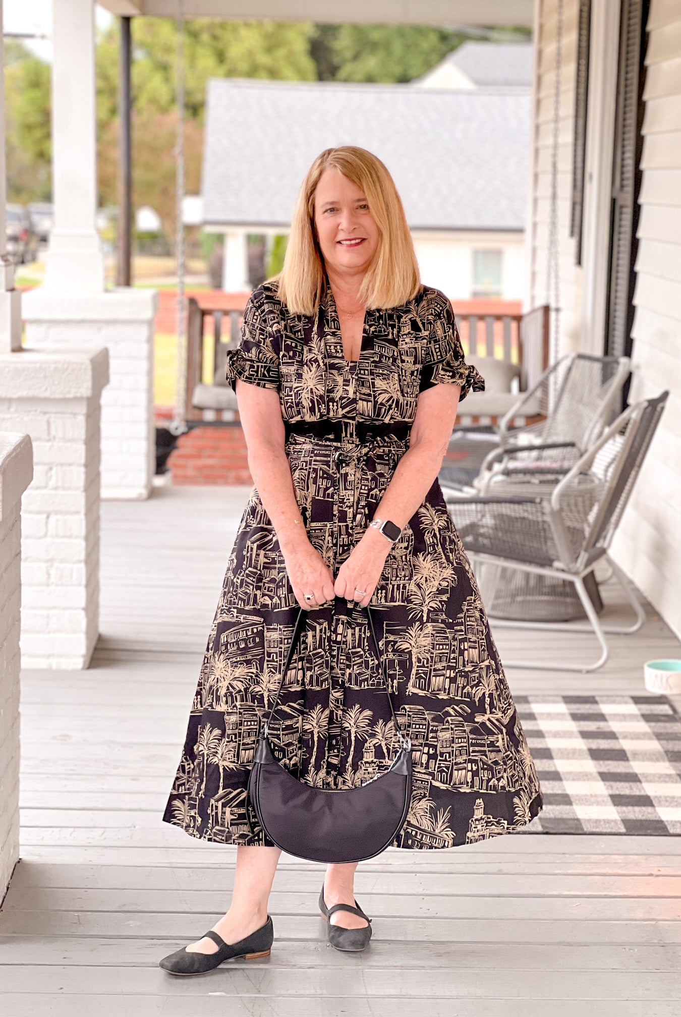 black dress with taupe pattern, midi length, v neckline