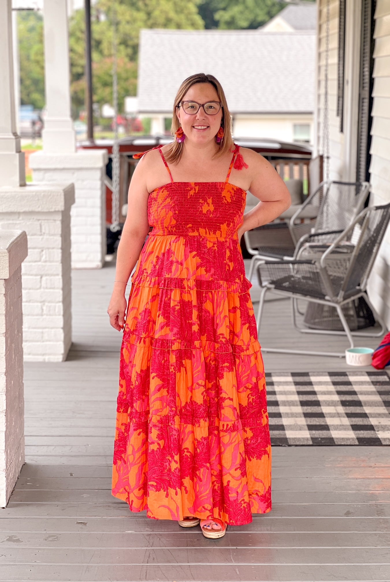red and orange maxi length dress with tiers and spaghetti straps