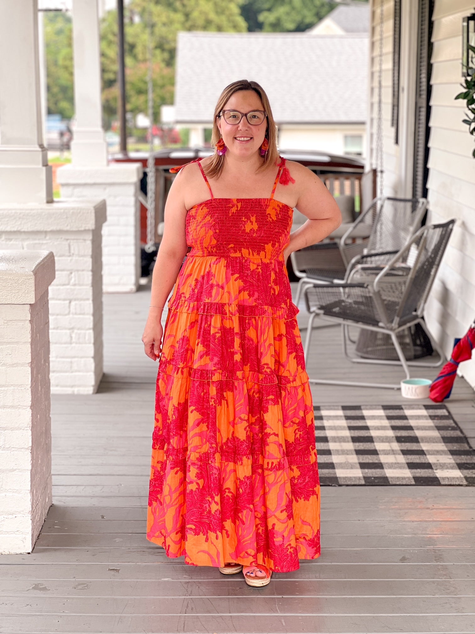 red and orange maxi length dress with tiers and spaghetti straps