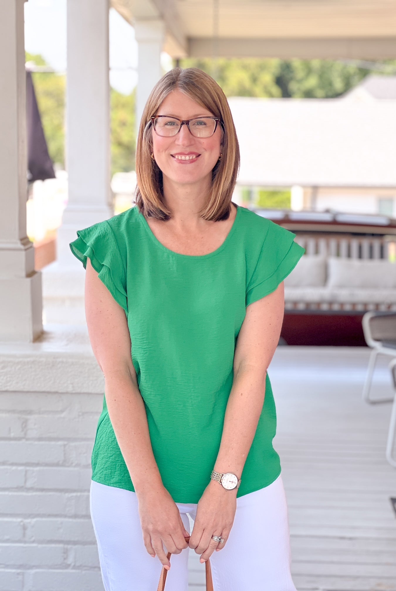 bright green top with short ruffle sleeves and a crew neckline