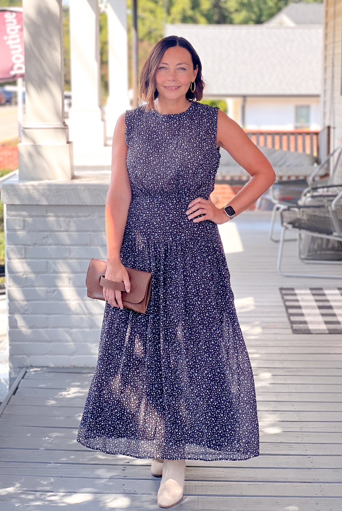 dark blue maxi length dress with small floral pattern, fitted at waist, sleeveless