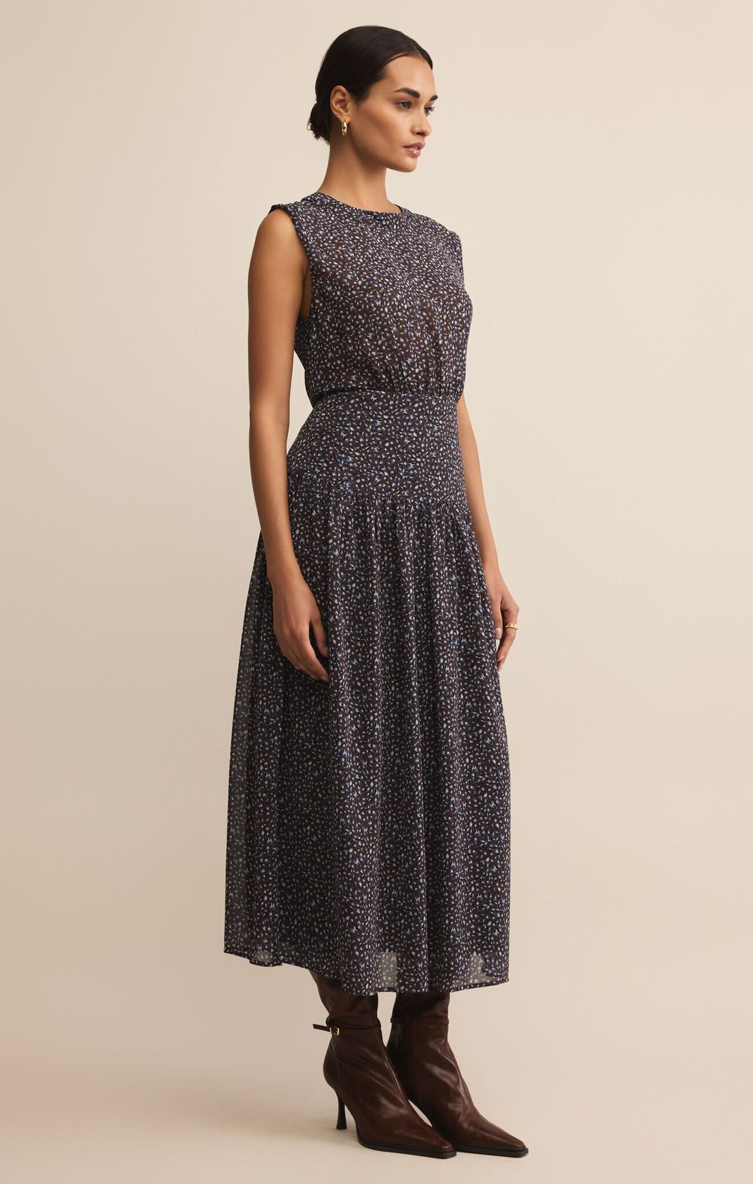 dark blue maxi length dress with small floral pattern, fitted at waist, sleeveless