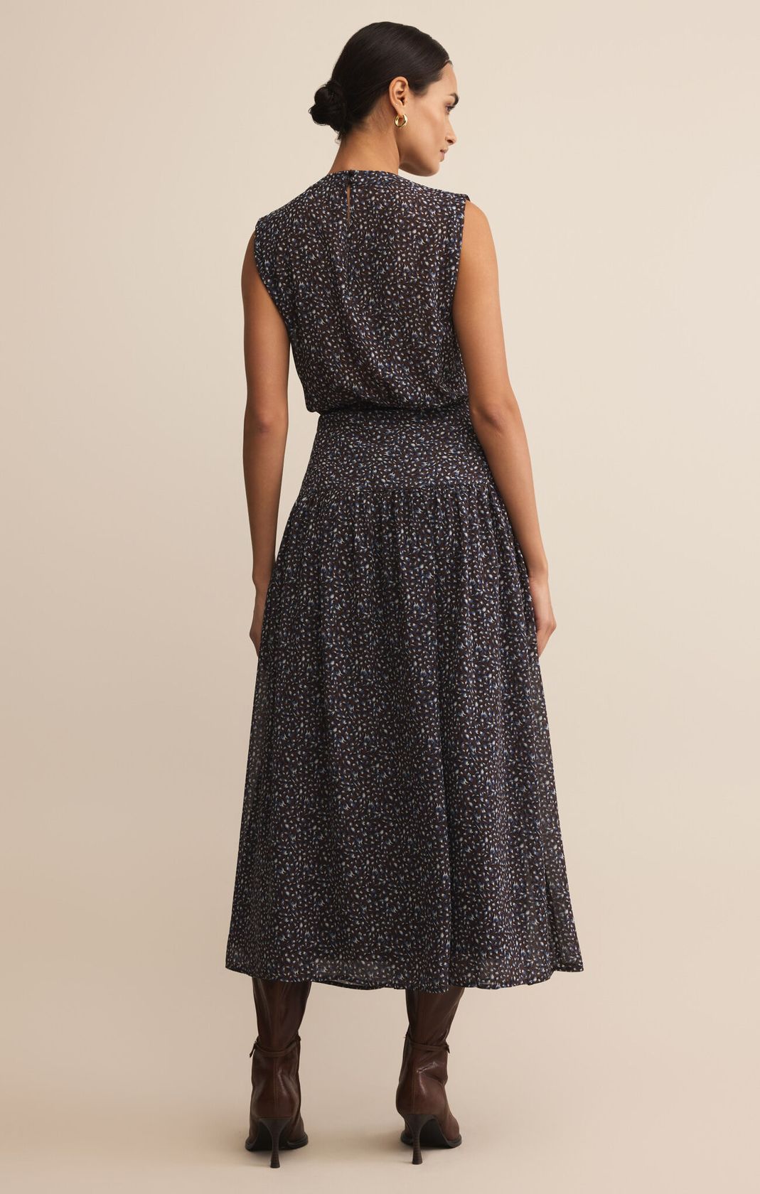 dark blue maxi length dress with small floral pattern, fitted at waist, sleeveless