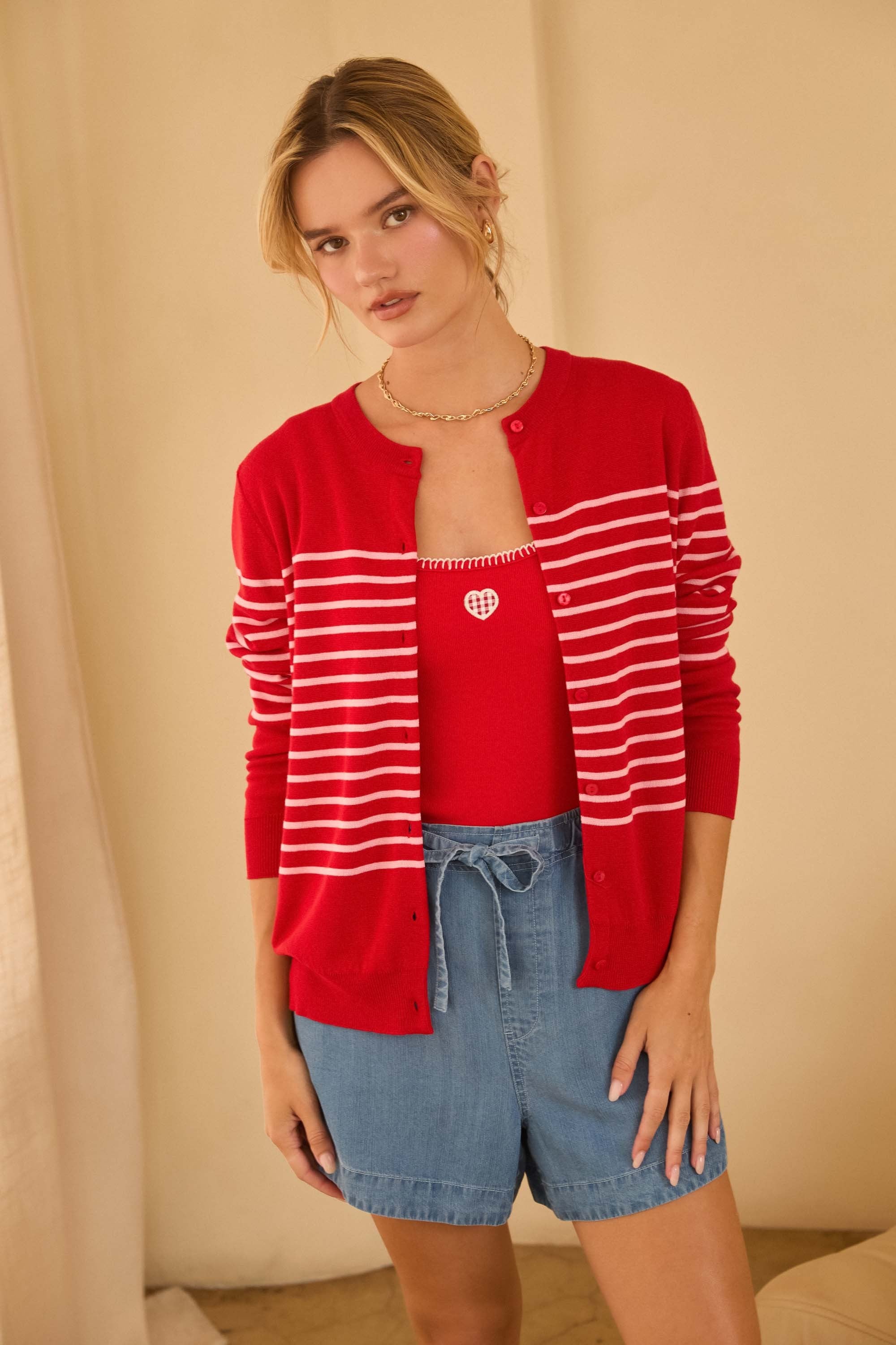 red cardigan with pink stripes in the middle