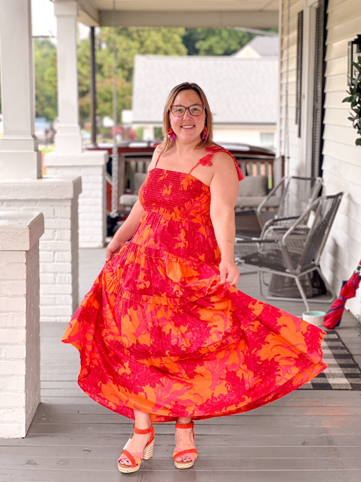 red and orange maxi length dress with tiers and spaghetti straps