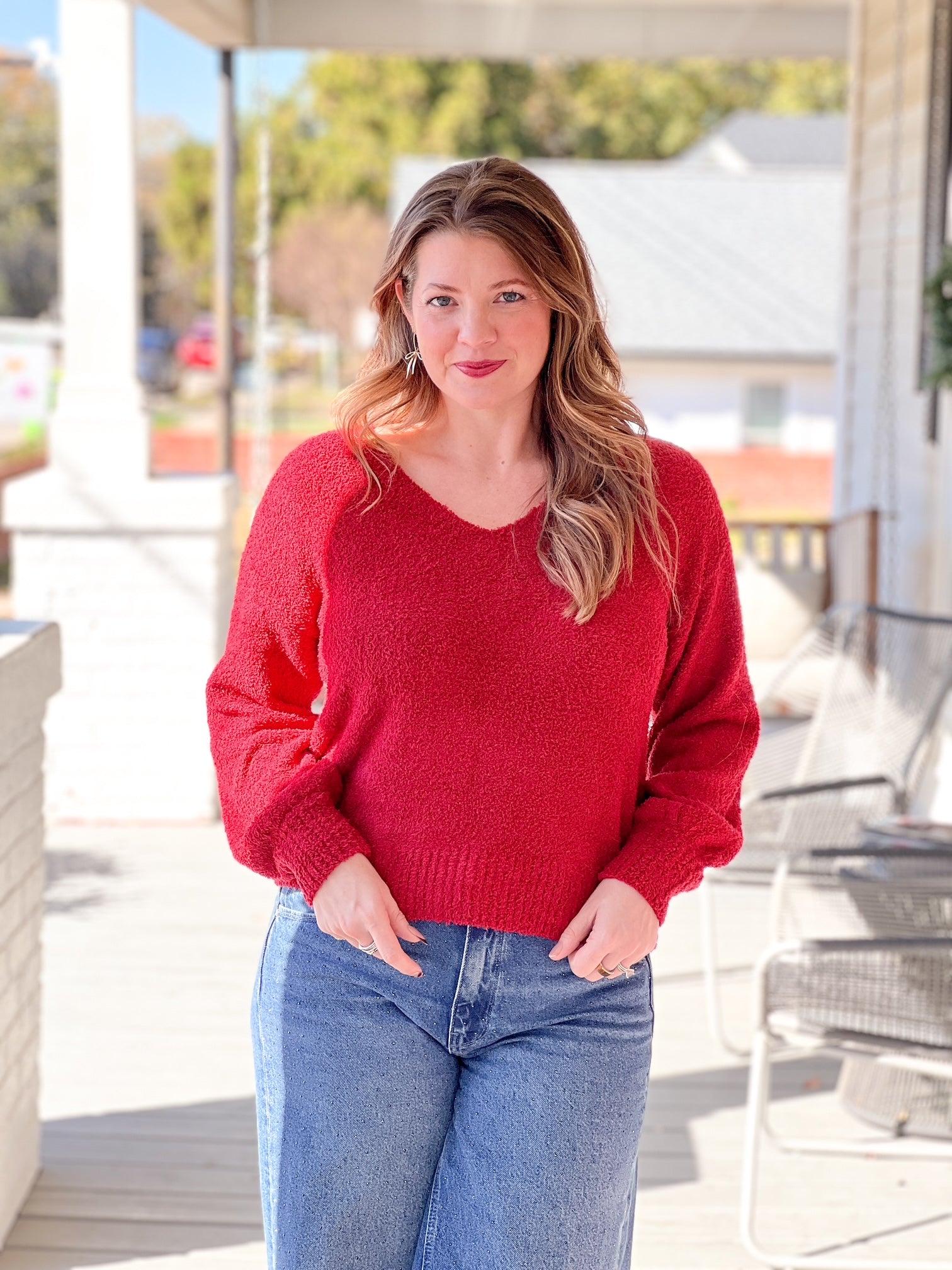 red sweater with v neckline and long sleeves
