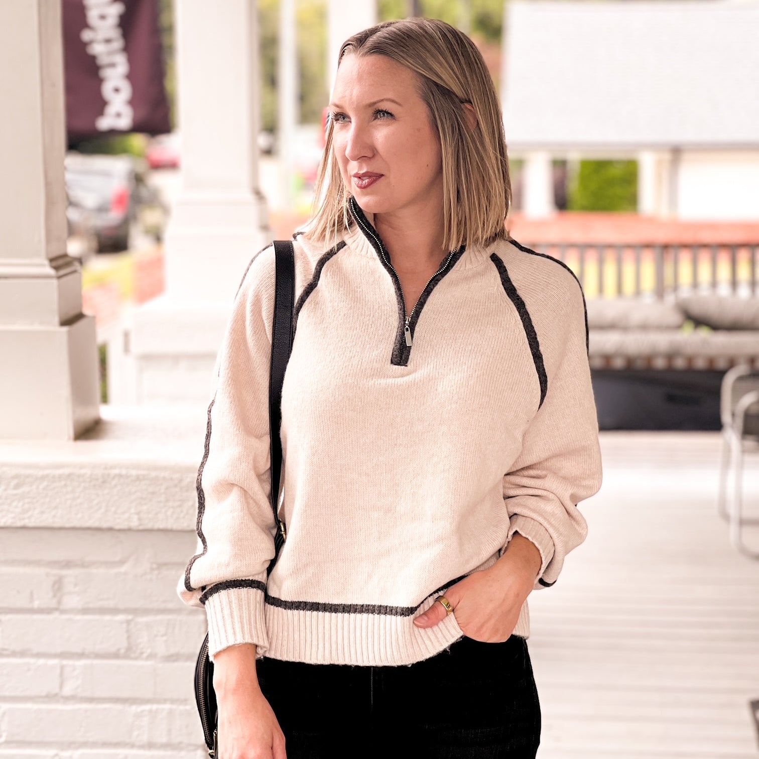 cream sweater with black outline, quarter zip
