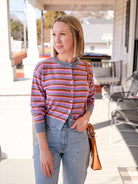 cardigan with light blue, pink, red and purple stripes