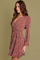 brown and cream patterned mini dress with v neckline