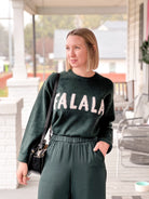 Soft Green Long Sleeve Sweater that says "Fa La La"