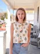 cream sleeveless top with floral pattern, button up front