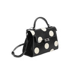 black handbag with large white polka dots