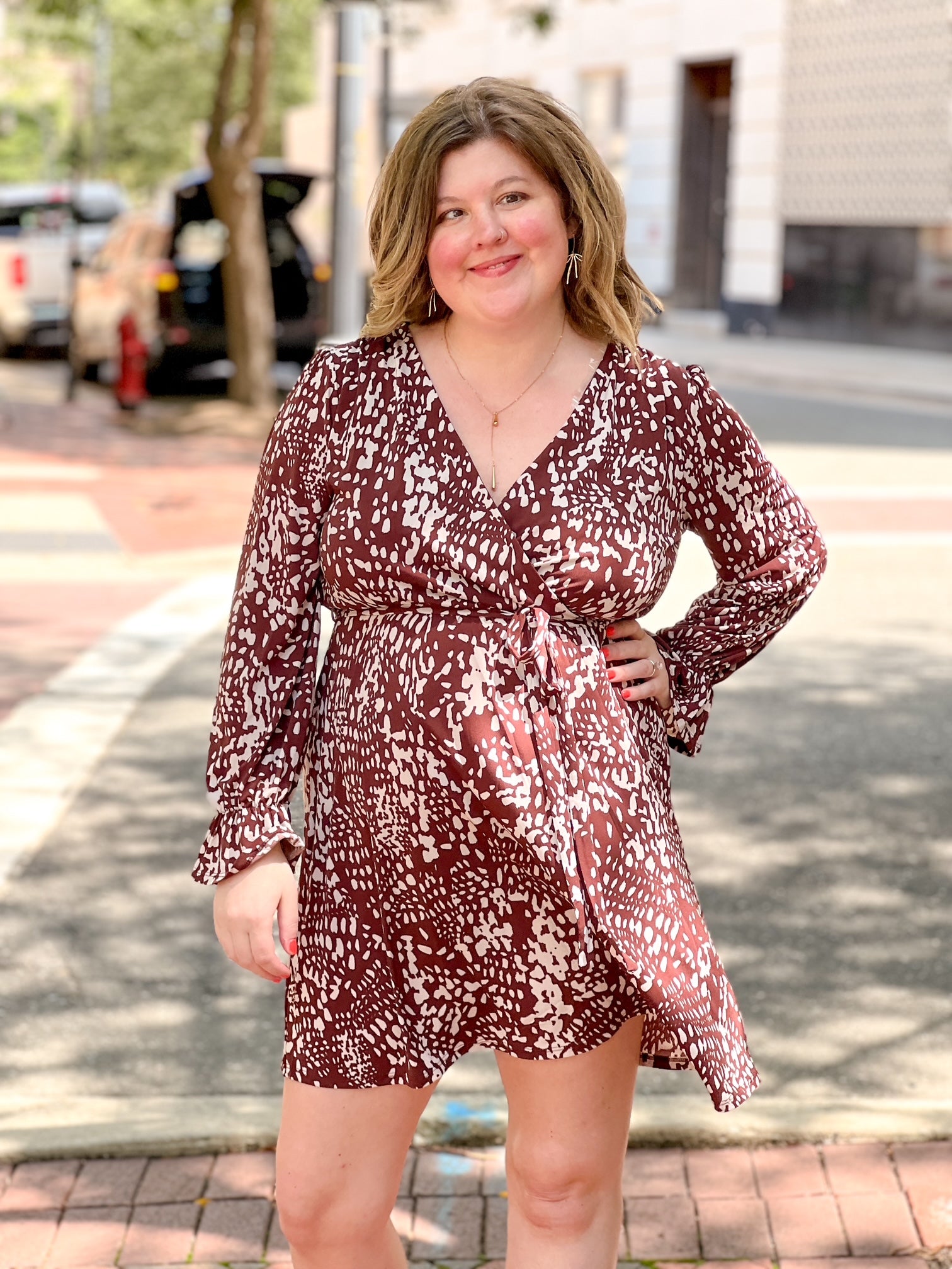brown and cream patterned mini dress with v neckline