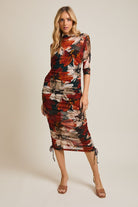 midi length orange, black and cream dress with 3/4 sleeves