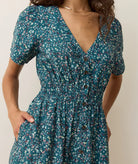 midi length a line dress with v neckline, teal floral pattern, short sleeves
