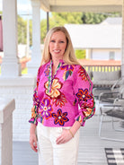long sleeve work top with v neckline, bright purple pattern with floral