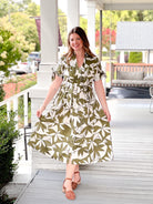 olive green dress with short sleeves, midi length, leaf pattern