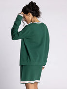 green cardigan with white and pink stripe outline