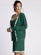 green cardigan with white and pink stripe outline