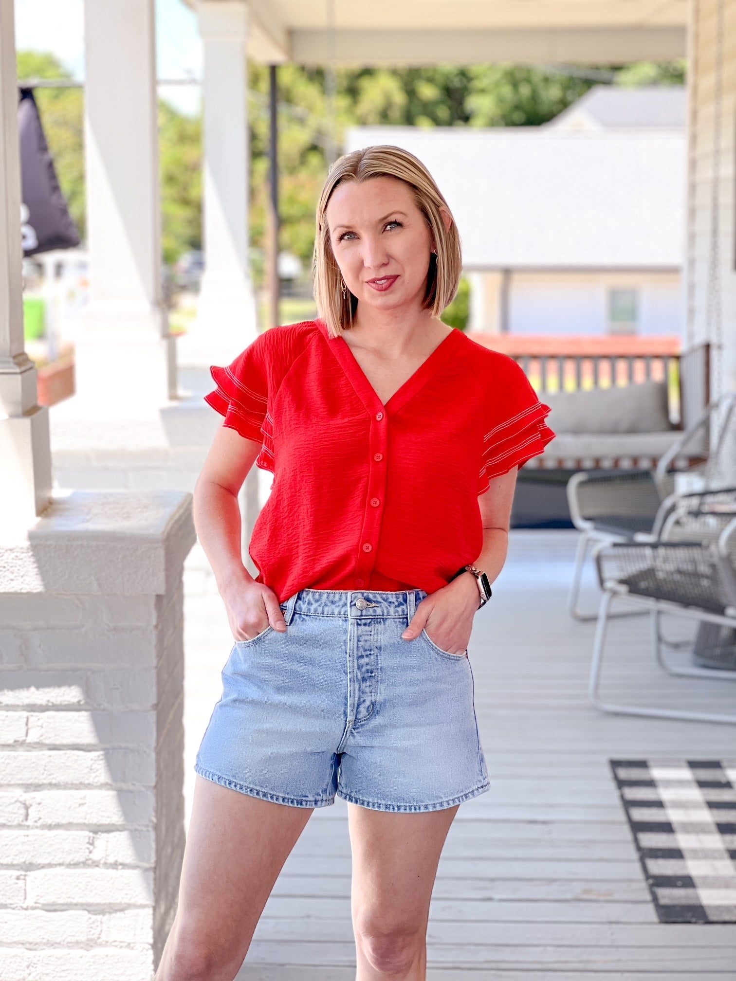 lightweight, short sleeve red top with button up detail and ruffle sleeves