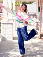 cream sweatshirt with colorful wave pattern across front