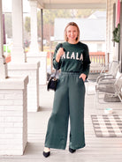 Soft Green Long Sleeve Sweater that says "Fa La La"