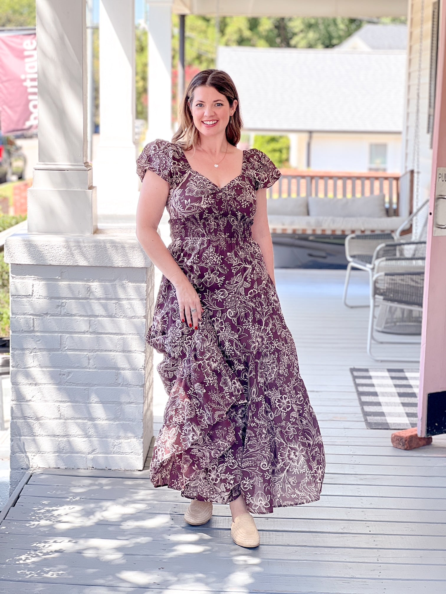 brown maxi length dress with floral pattern and sweetheart neckline