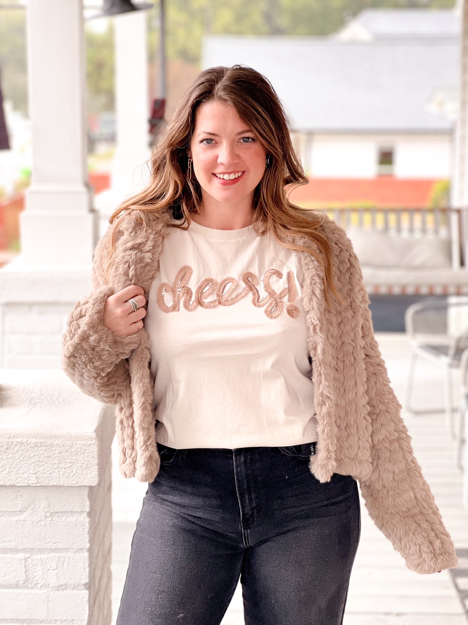 cream short sleeve top with cheers written on the front