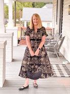 black dress with taupe pattern, midi length, v neckline