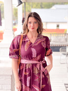 wine colored dress with leaf pattern, v neckline, a line fit