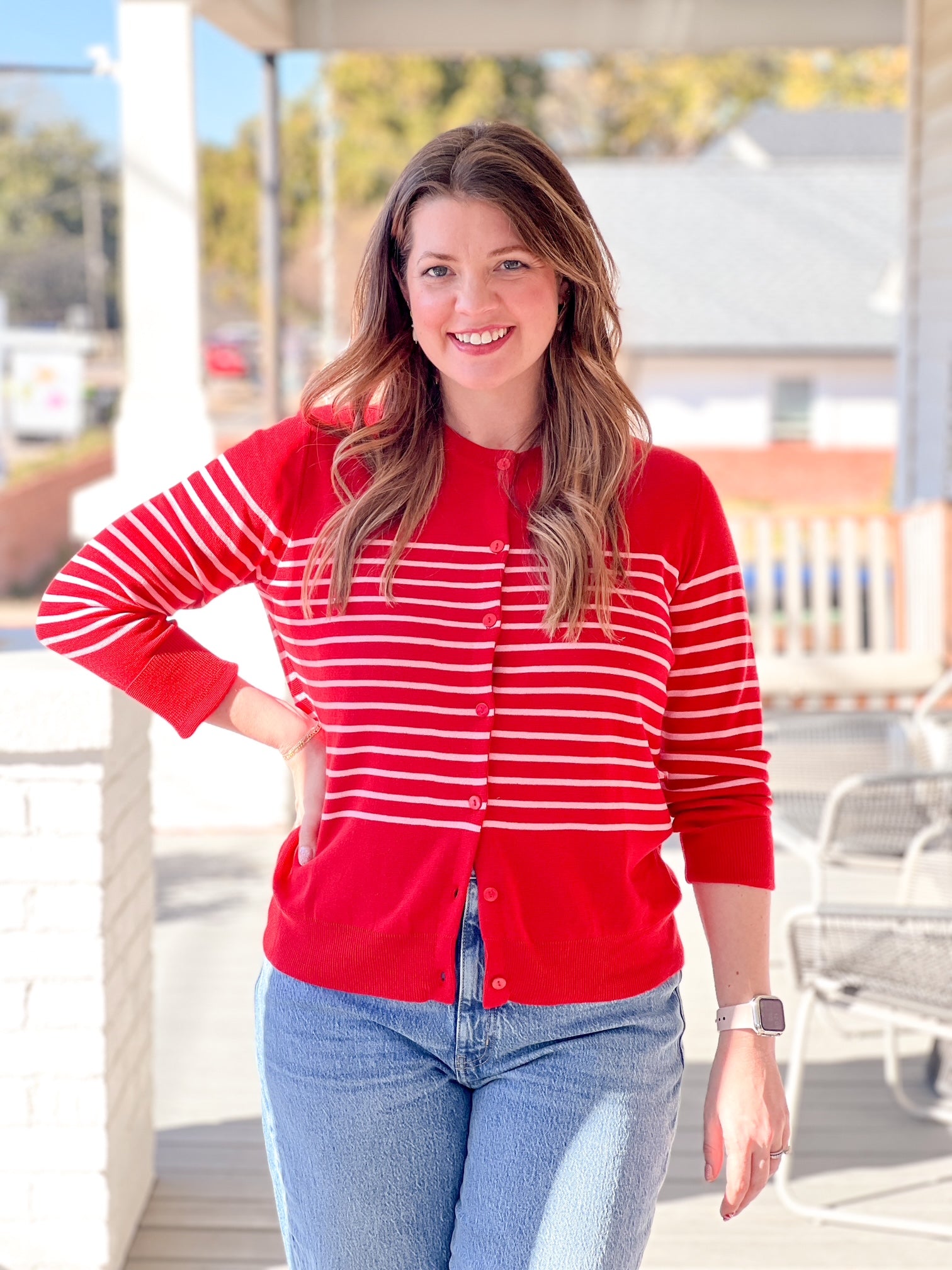 red cardigan with pink stripes in the middle
