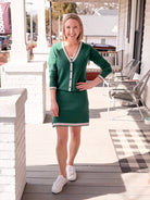 green cardigan with white and pink stripe outline