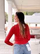 red long sleeve collared v neckline button front top