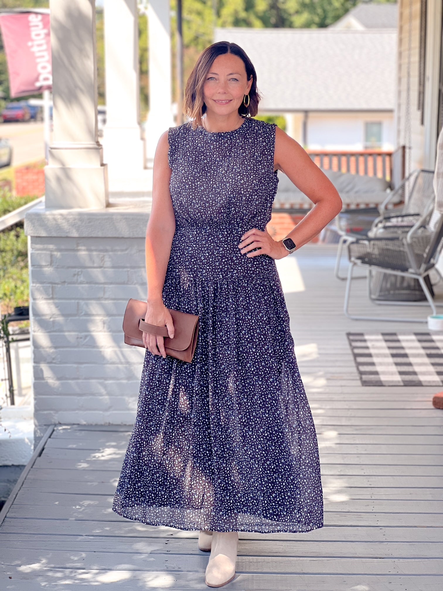 dark blue maxi length dress with small floral pattern, fitted at waist, sleeveless
