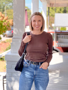 dark brown long sleeve top with crew neckline