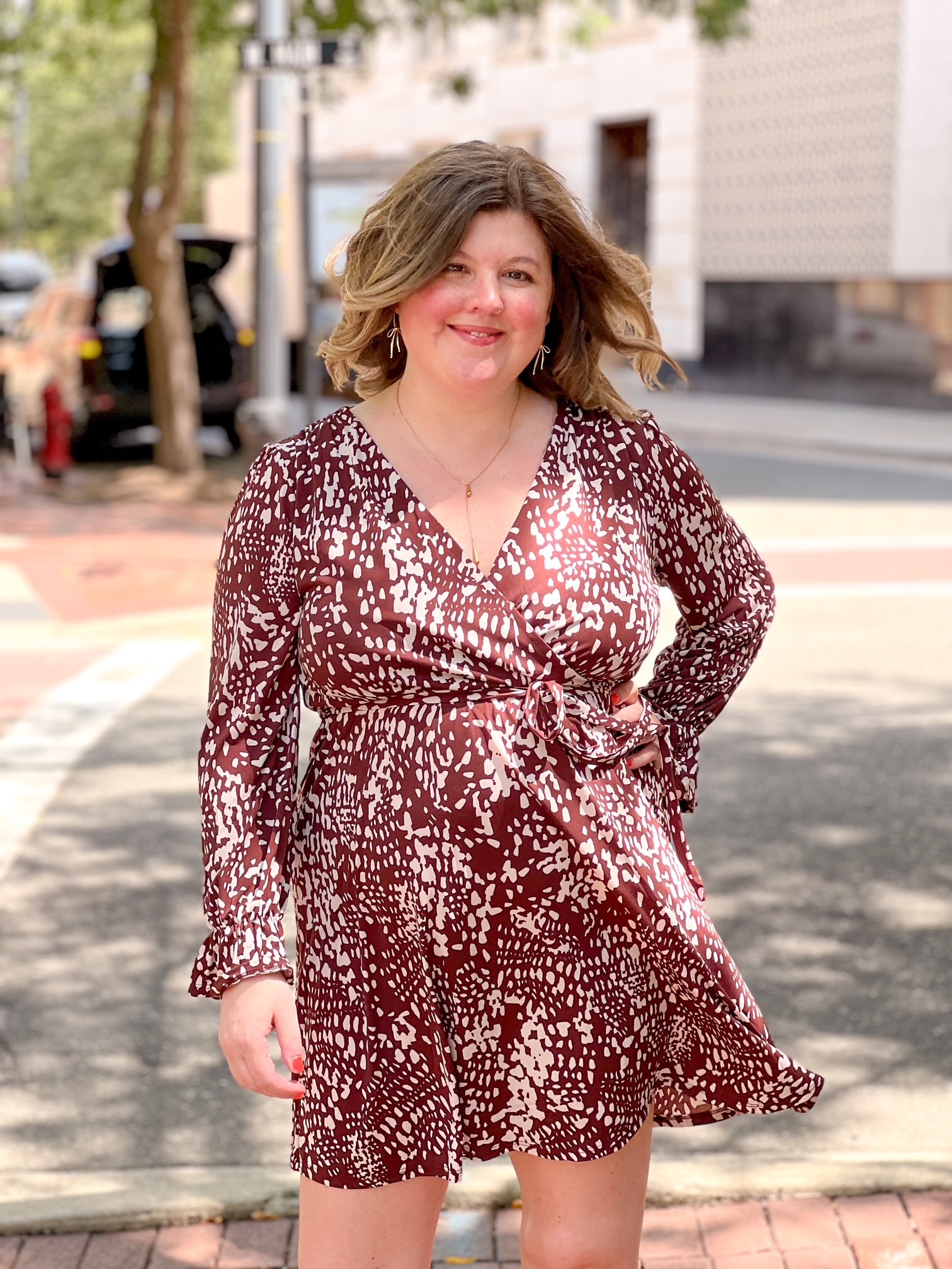 brown and cream patterned mini dress with v neckline