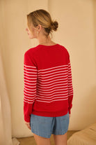 red cardigan with pink stripes in the middle