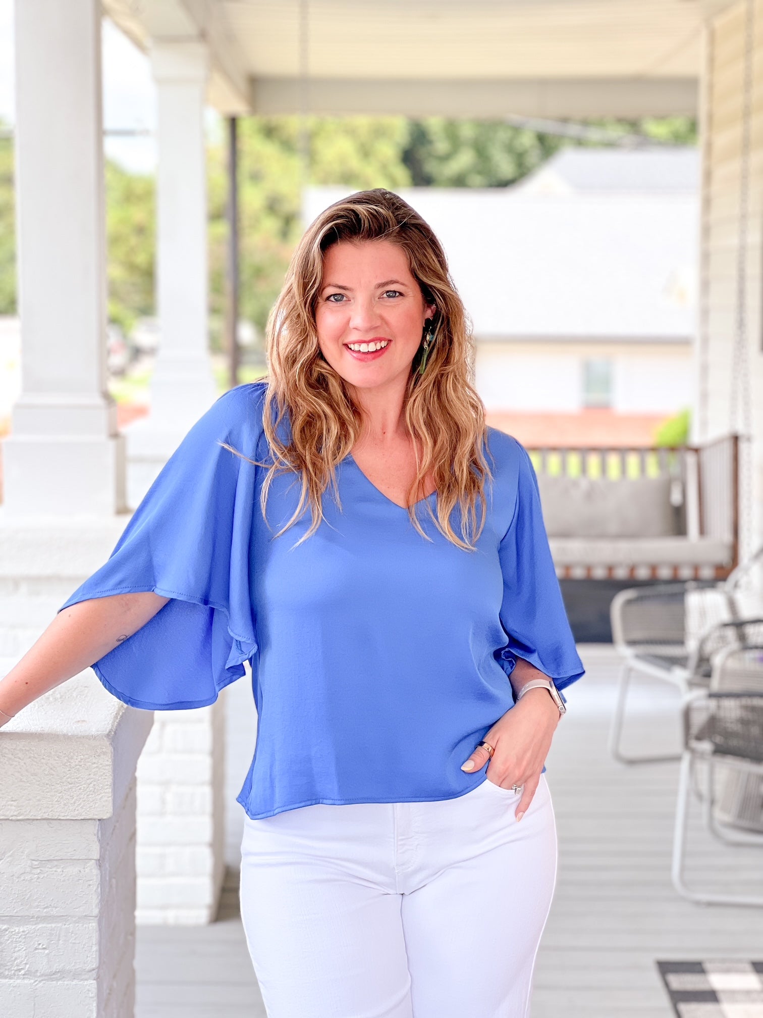 blue top with 3/4 flowing sleeve and v neckline