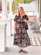 black dress with taupe pattern, midi length, v neckline